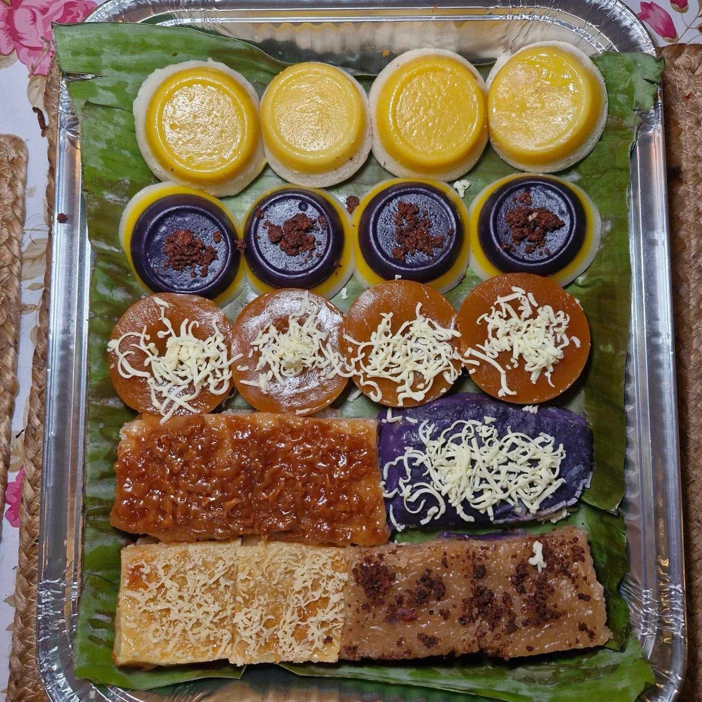 Assorted kakanin tray with puto flan, sapin-sapin, kutsinta, ube halaya, cassava cake, and biko